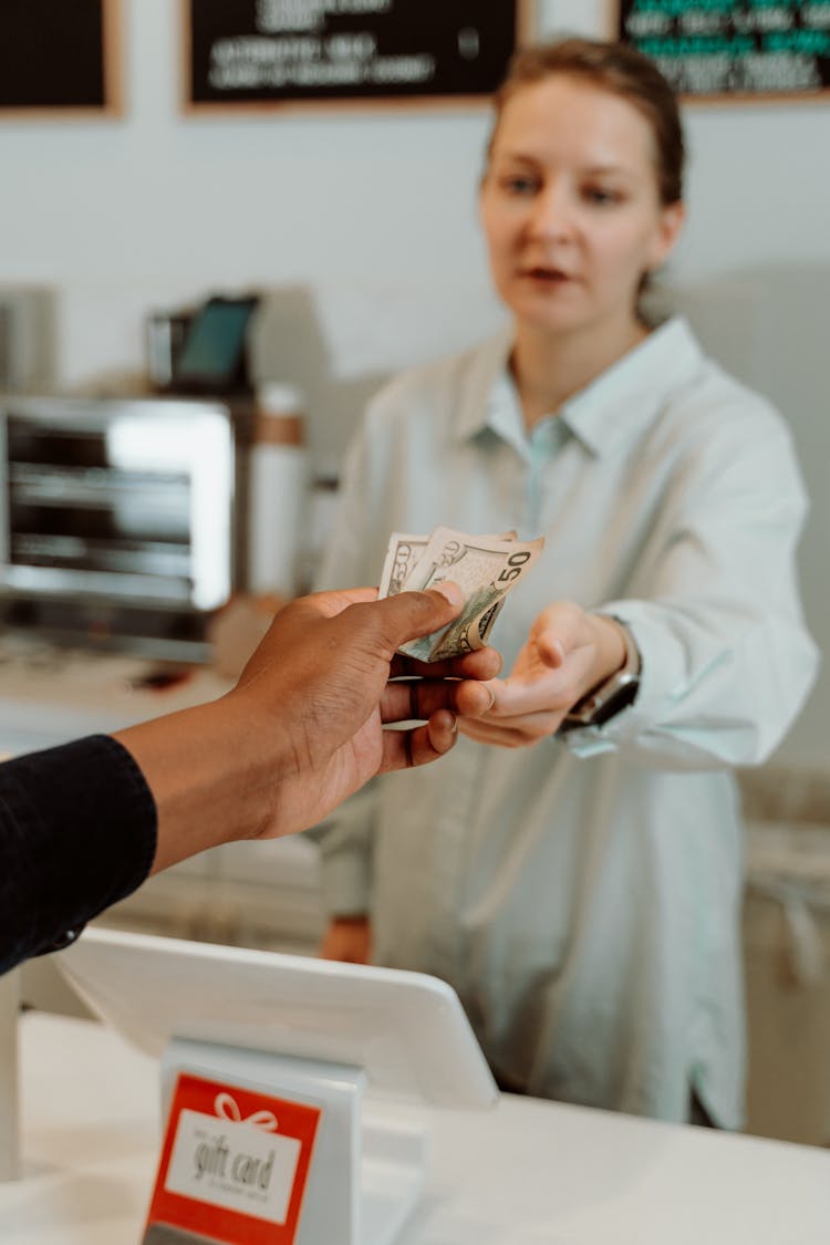 Person Paying On A Cashier 