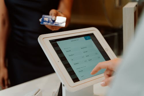 Close-Up Shot of a Person Taking Orders Through Order Terminal