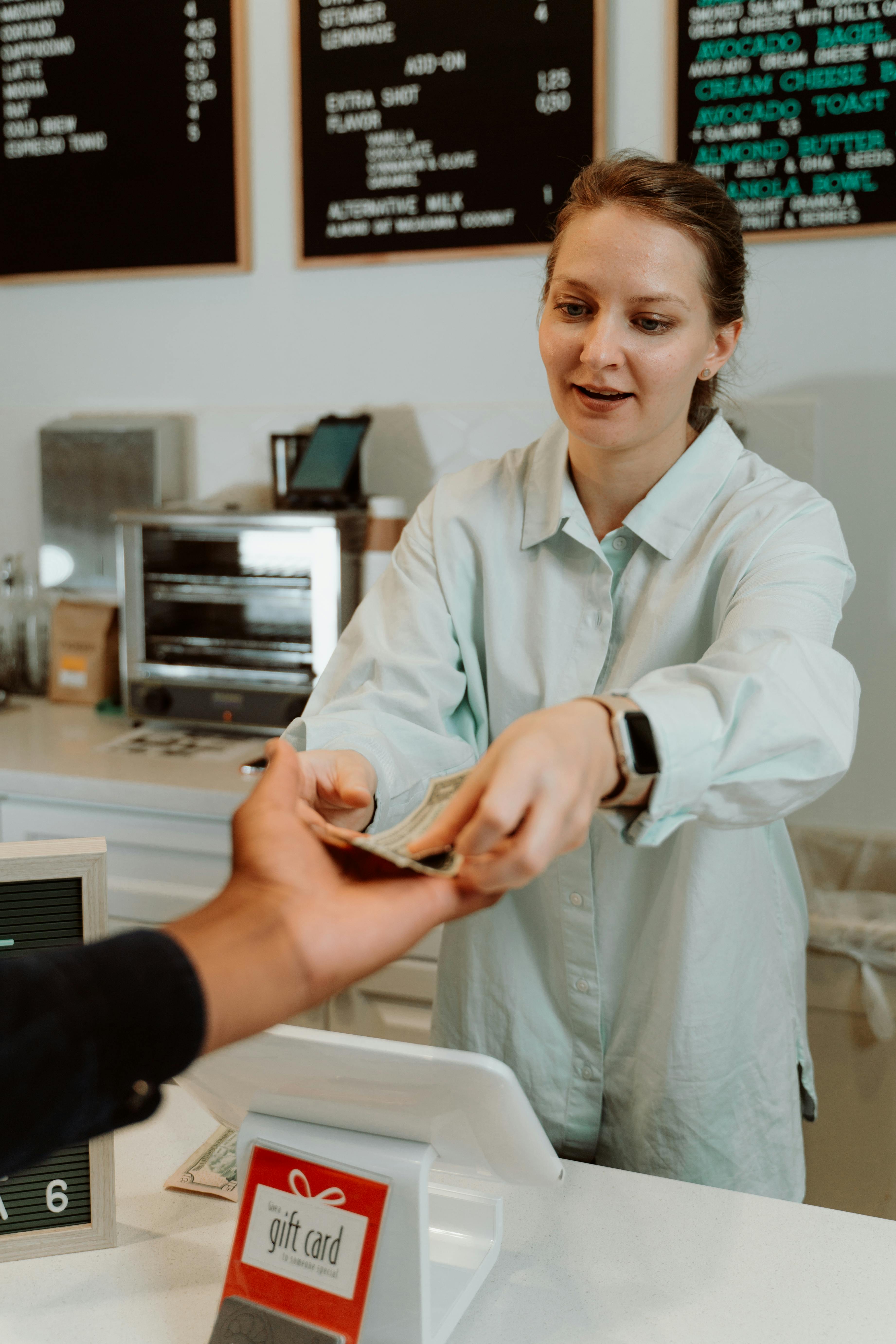 a woman receiving money from the customer