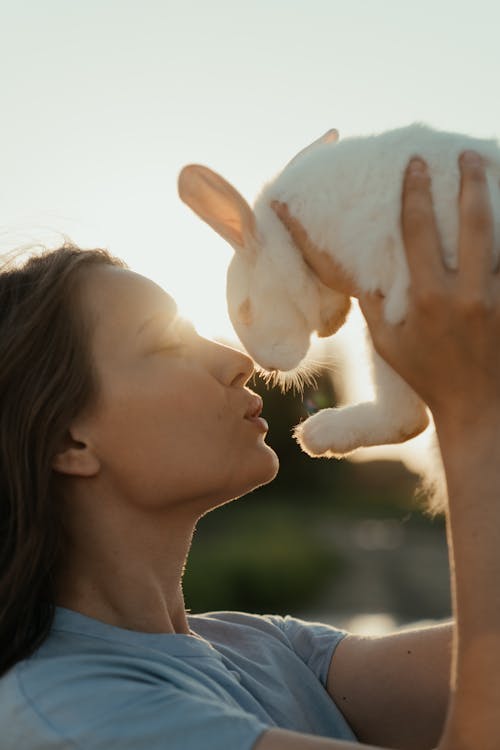 Woman in Black Tank Top Holding White Rabbit