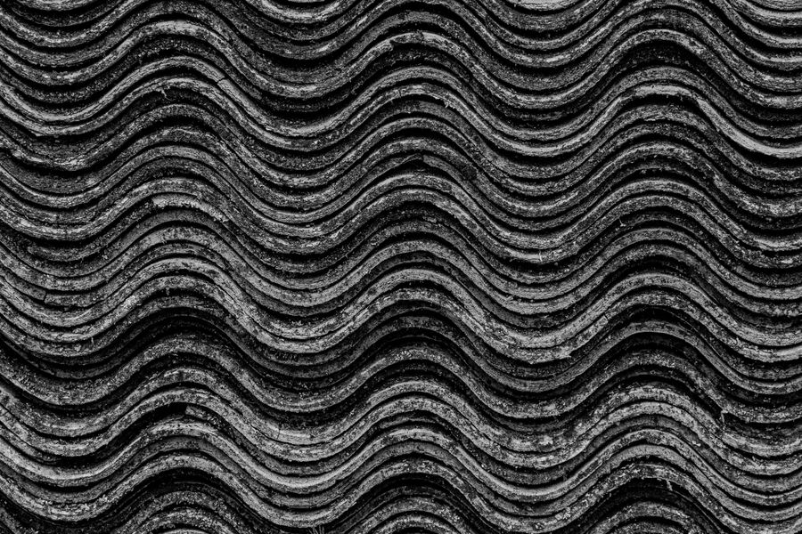 Black and white abstract image featuring wavy patterns in a textured surface for creative backgrounds and design projects.