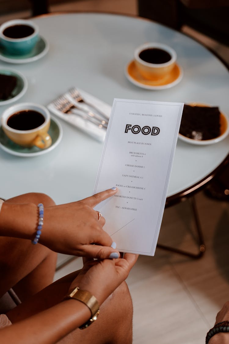 Person Holding A Menu