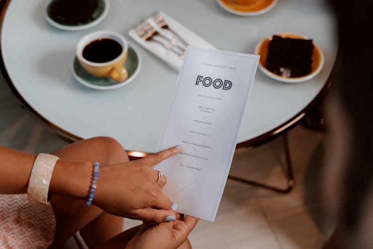 Person Holding A Menu