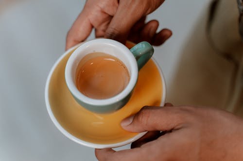 Free Close-Up Shot of a Person Holding a Cup of Coffee Stock Photo