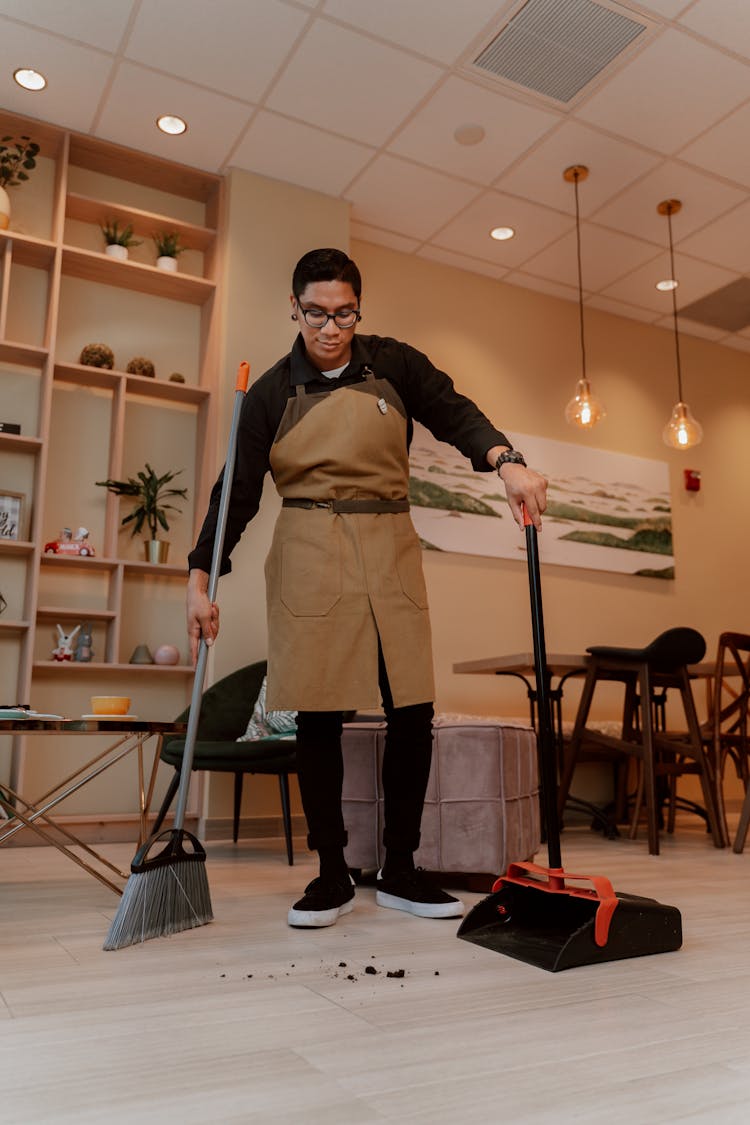 Man Sweeping The Floor