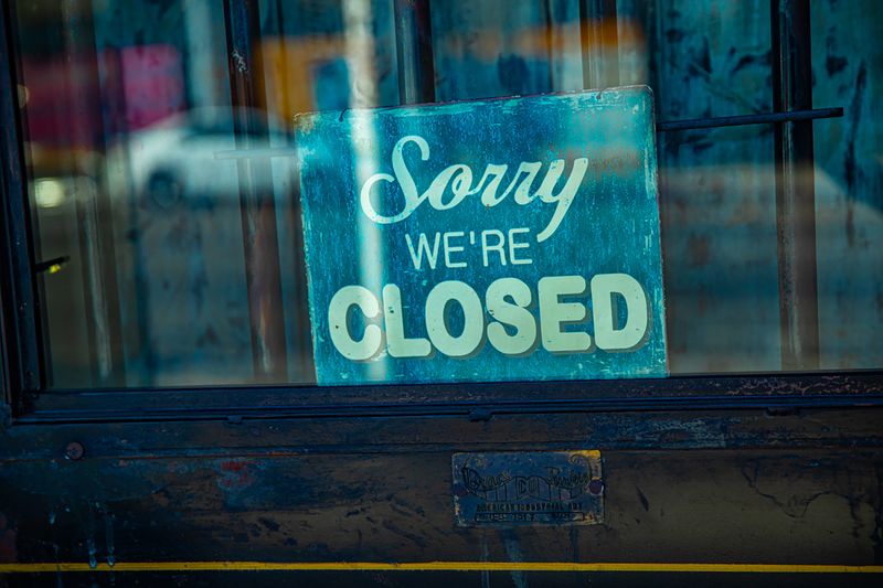 Empty storefront with signage on the glass door
