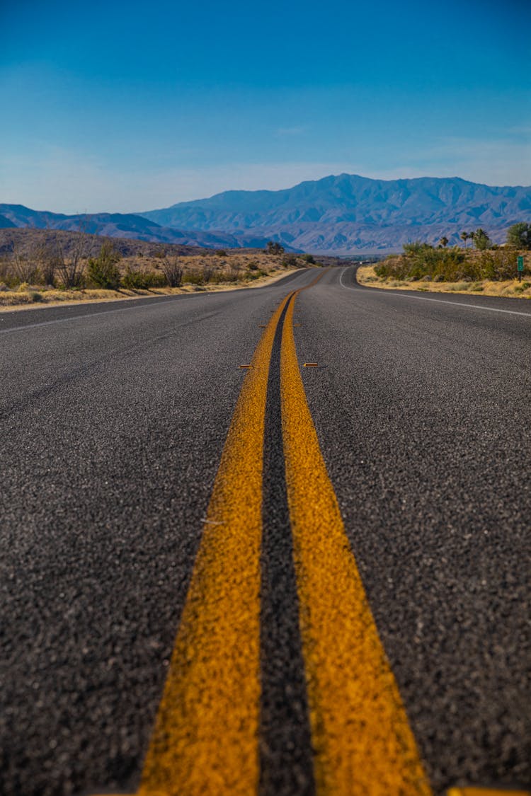 A Pair Of Solid Yellow Markings On Asphalt Road 