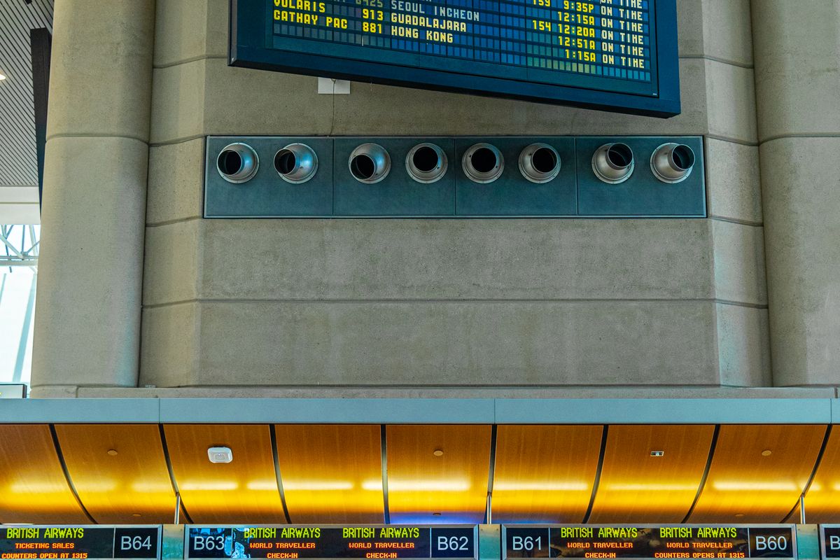 Traveller checking flight information screens in a terminal