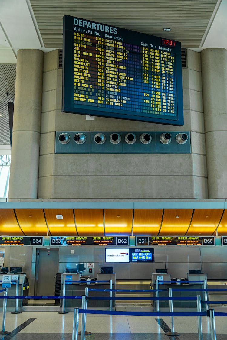 A Screen With Departure Information Mounted On Wall