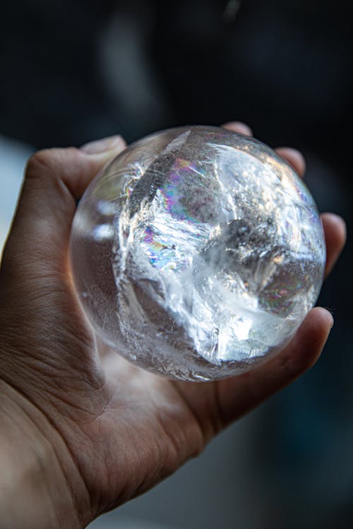 Person Holding Clear Glass Ball
