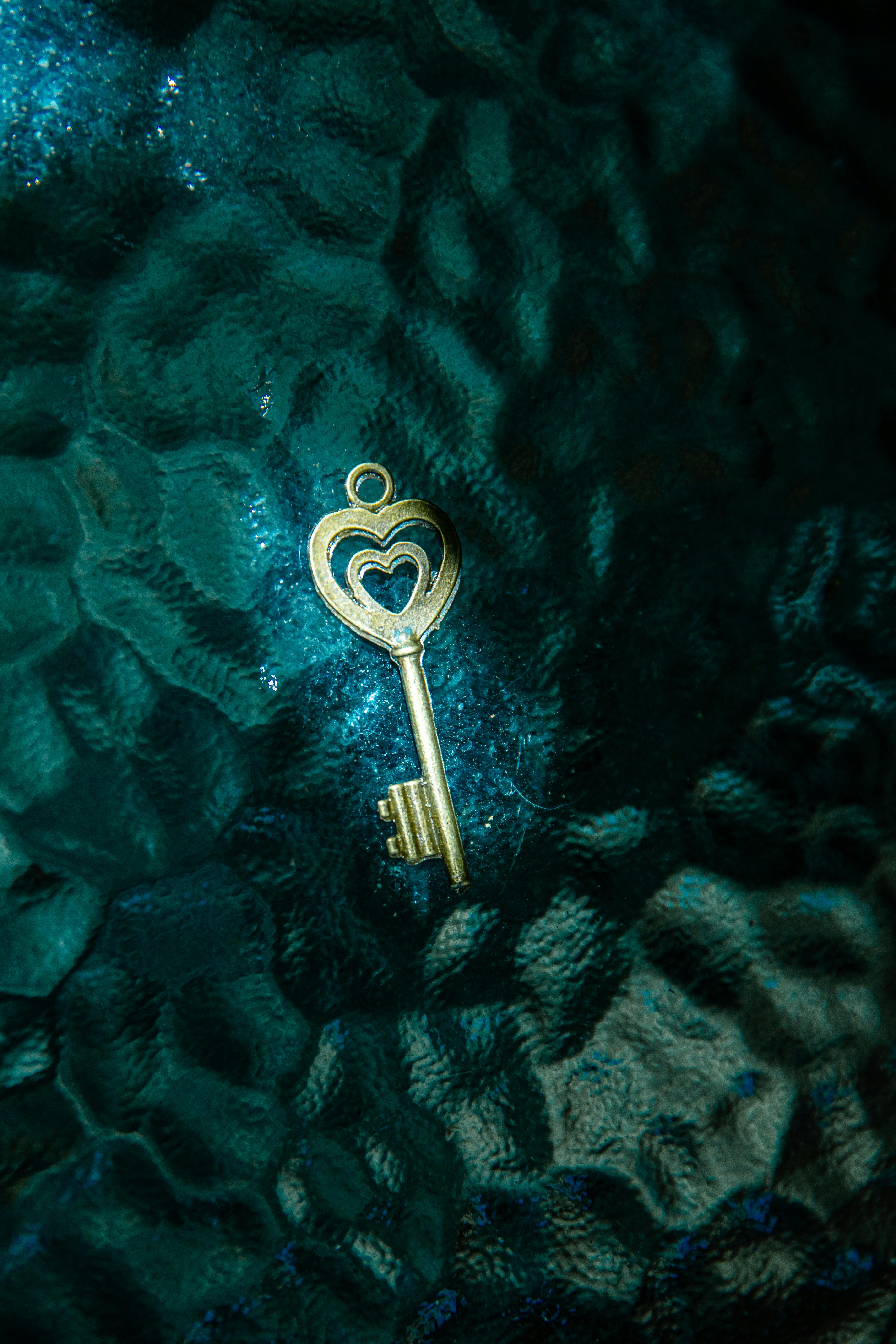 gold key on green textile