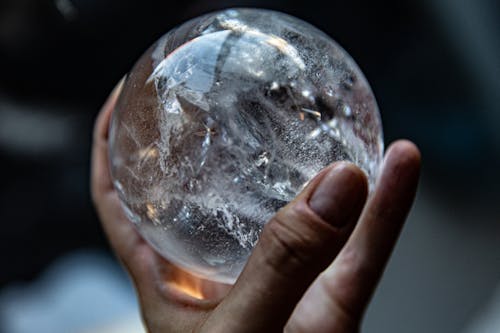 Person Holding Clear Glass Ball