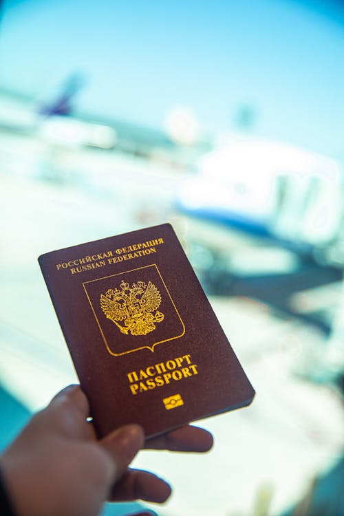 Free Person Holding a Passport Stock Photo