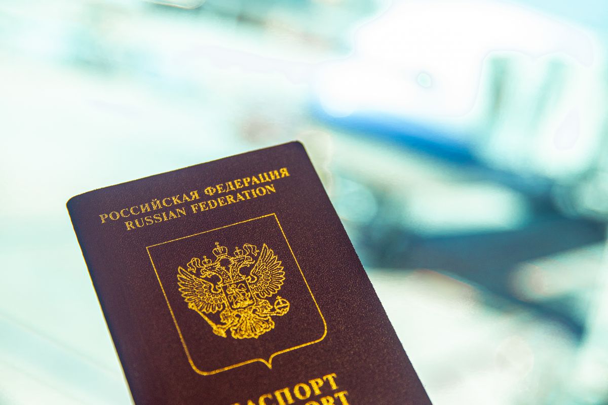 A passport held in a traveller's hand