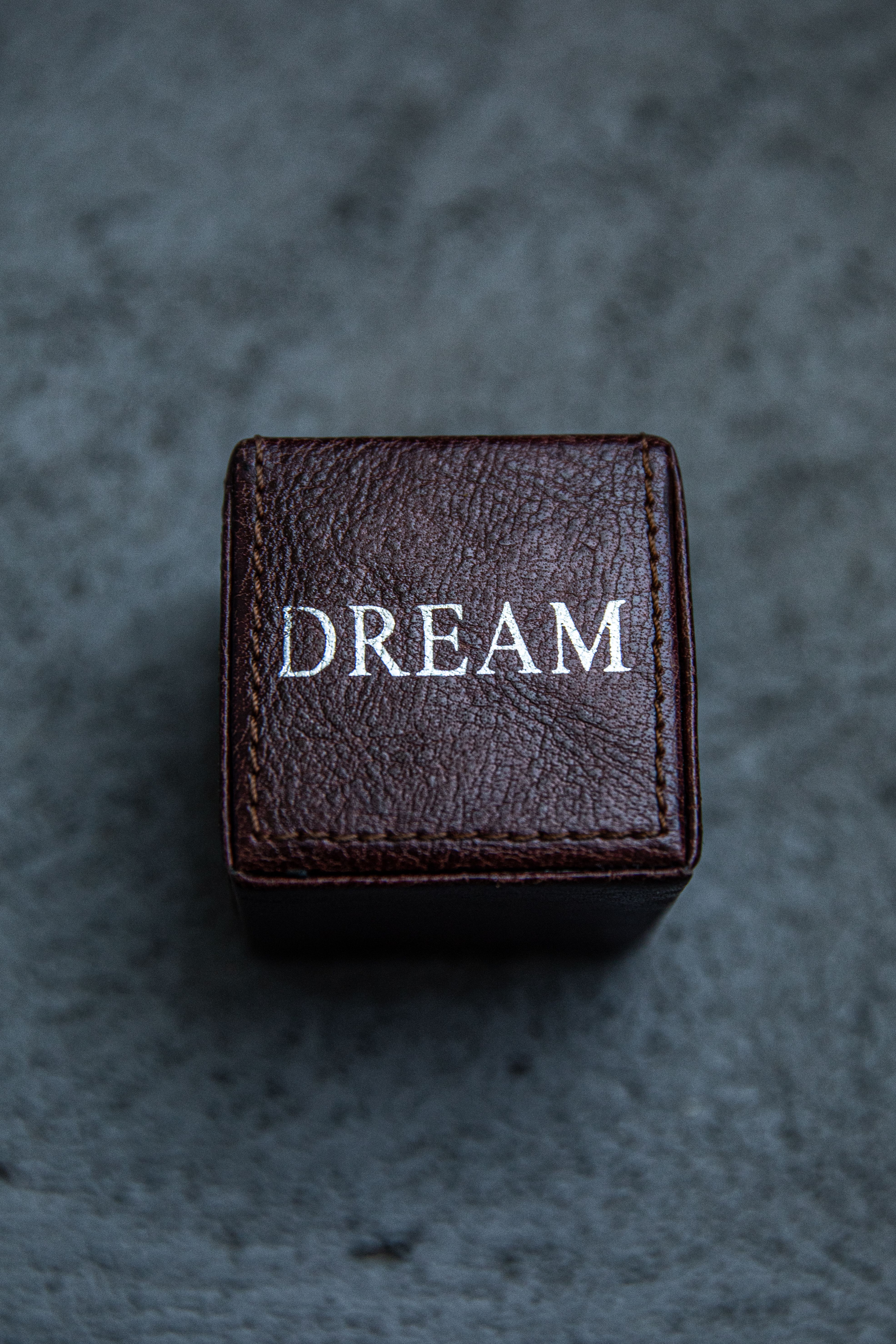 Close-up of a leather box featuring the word 'DREAM' embossed on it.