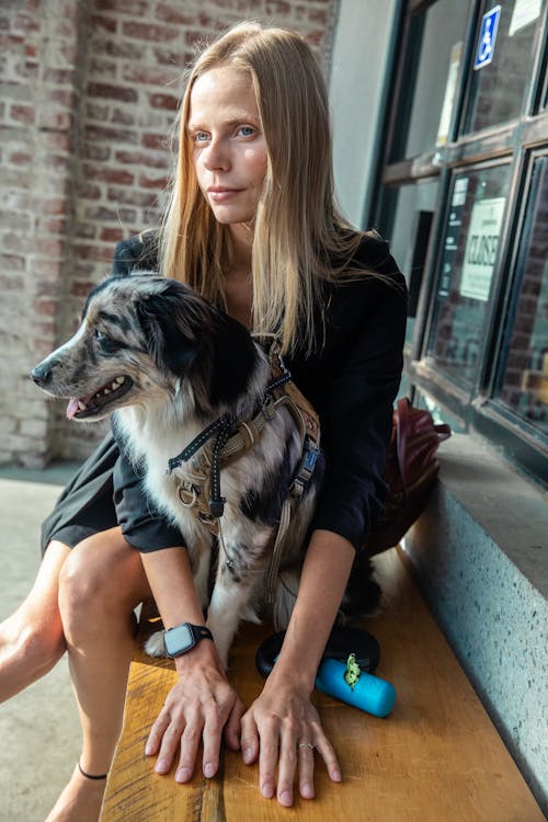 Female Pet Owner sitting closed to her Dog 