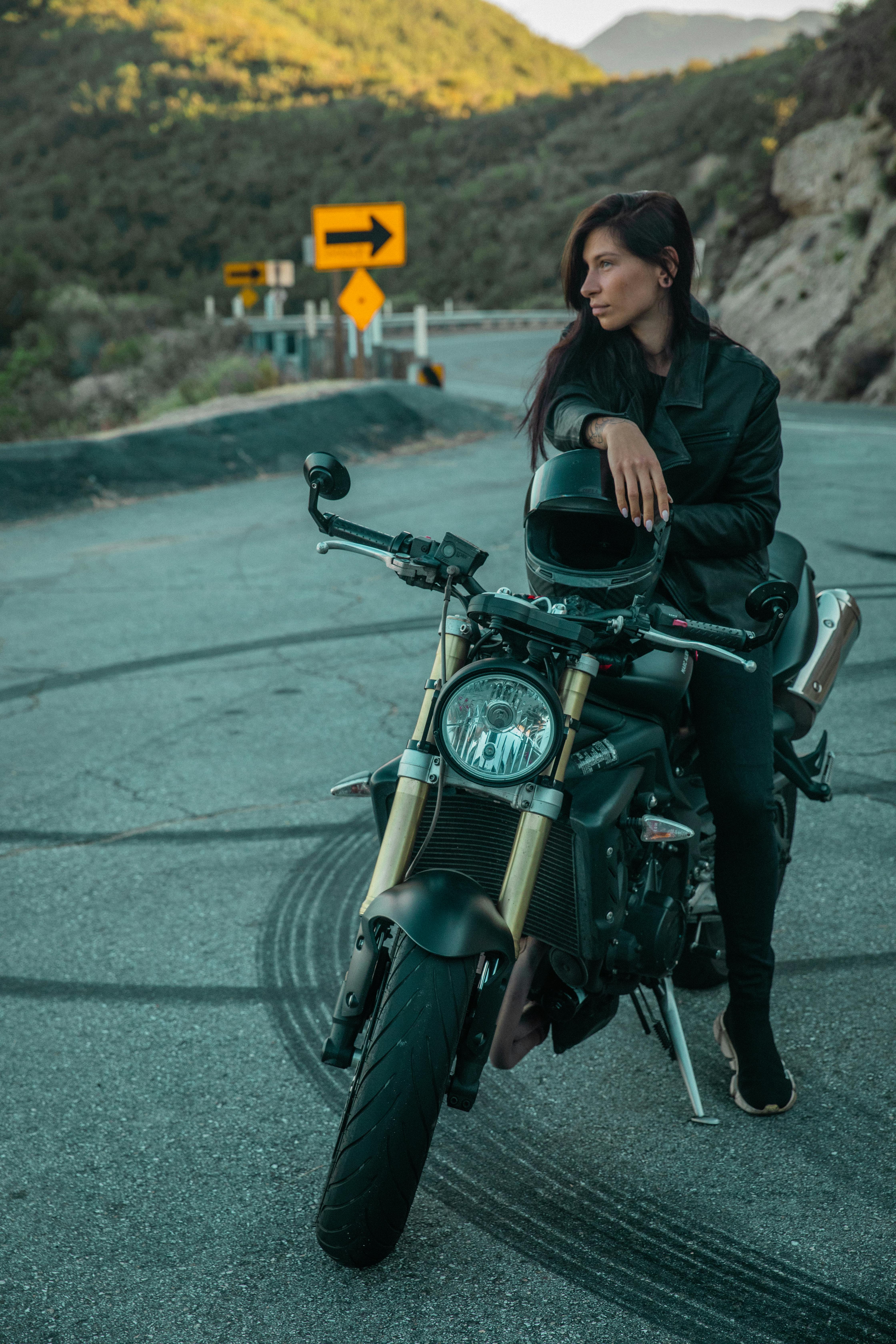 A Person in a Black Jacket Riding a Black Motorcycle on the Road · Free  Stock Photo