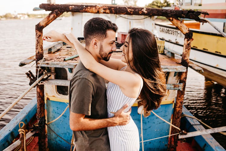 Joyful Couple Hugging On Weathered Boat