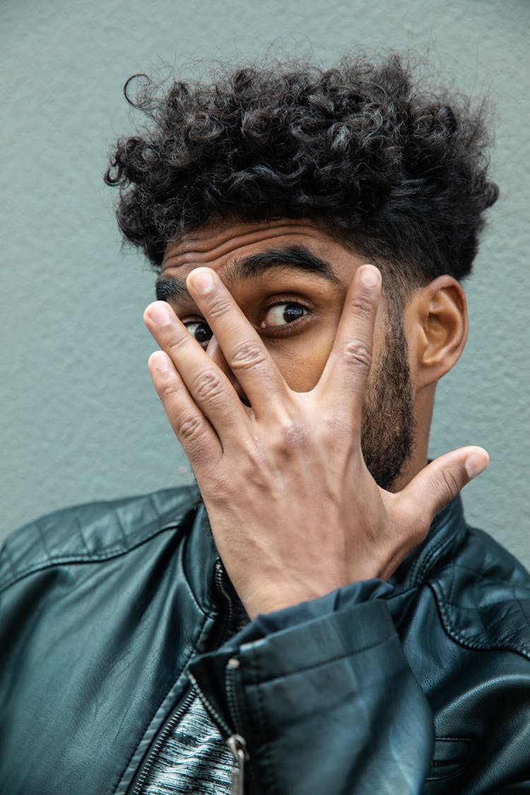 Man In Leather Jacket Covering His Face