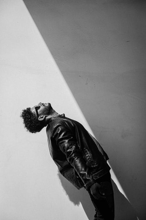 A Man in a Leather Jacket Looking Up 