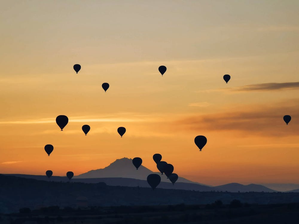 Free Bunch of air balloons at sunset Stock Photo