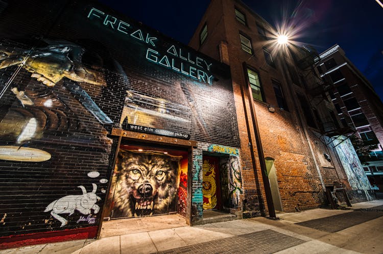 Old Building Exterior With Colorful Graffiti Walls At Night