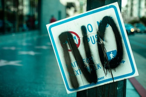Free Close Up photo of a Vandalized Street Sign Stock Photo