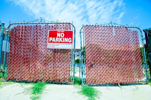 No Parking Sign Hanging on a Gate