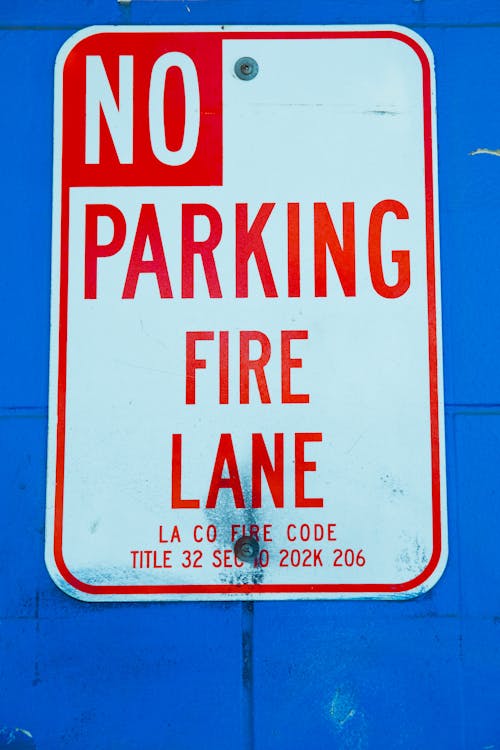 Free No Parking Sign on Blue Surface Stock Photo