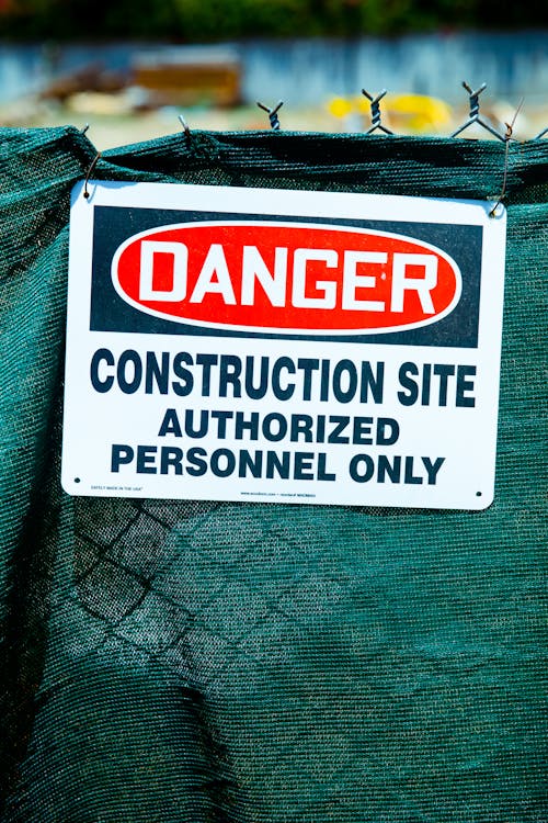 Free Danger Sign on a Wire Fence Stock Photo