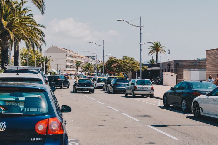Cars parked in a roadside lot near a French Mediterranean beach
