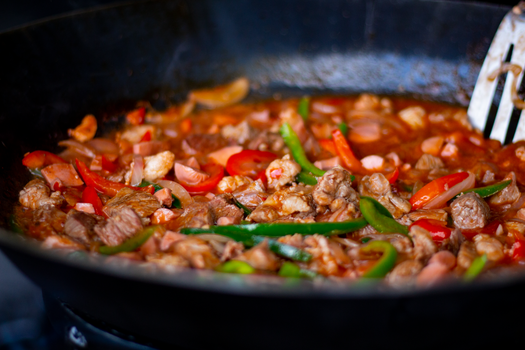 Delicious Mexican stir fry featuring bell peppers and tender meat in a sizzling pan.
