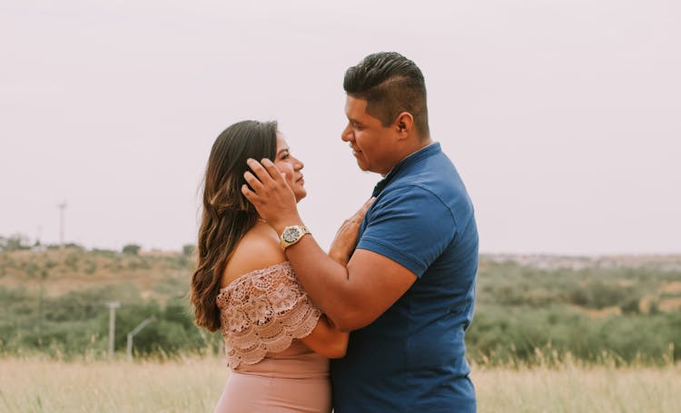 Happy Hispanic Couple In Field