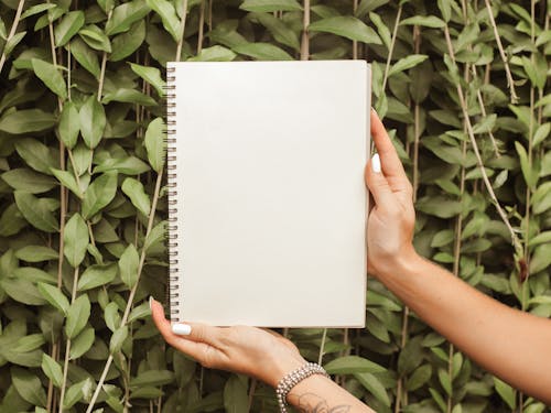 A Person Holding a Blank Notebook