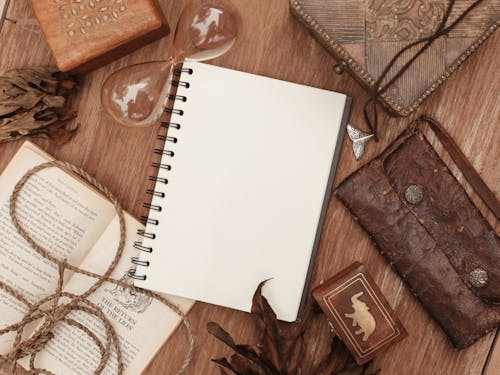 Free Notebook Beside Wooden Boxes and Bag Stock Photo