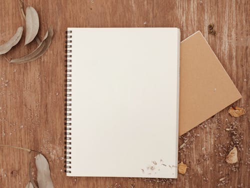 White Notebook on Wooden Surface