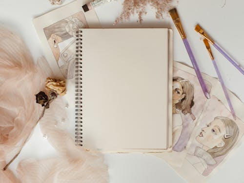 Free Close-Up Shot of a Notebook on a White Surface Stock Photo