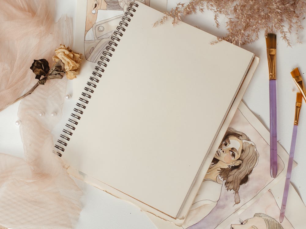 Close-Up Shot of a Notebook on a White Surface