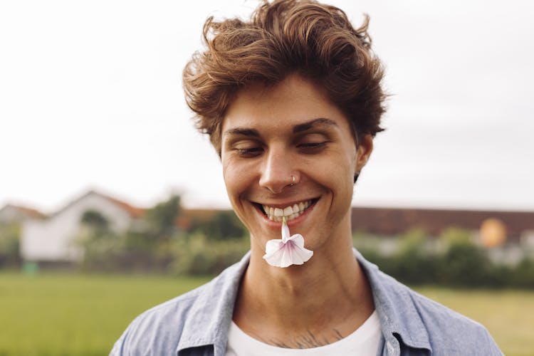 Good Looking Man Biting A Flower