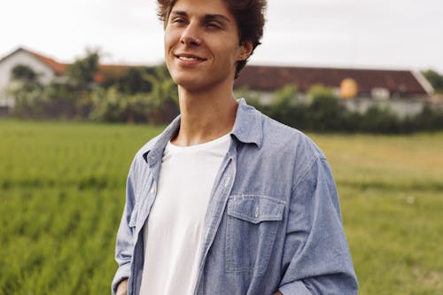 Young Man in a Blue Shirt on a Field 