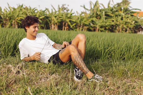 Young Man Lying in Agricultural Field 