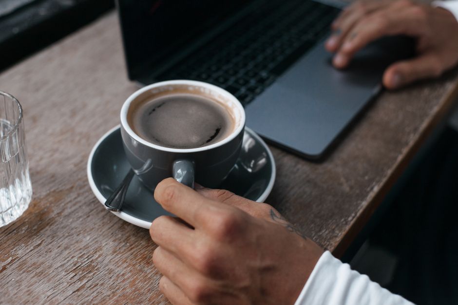 A person working on a laptop in a cozy cafe in Riga, Latvia, connected to public Wi-Fi