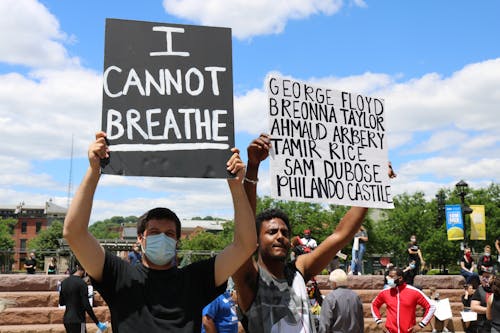 People Holding Placards Protesting Outdoors