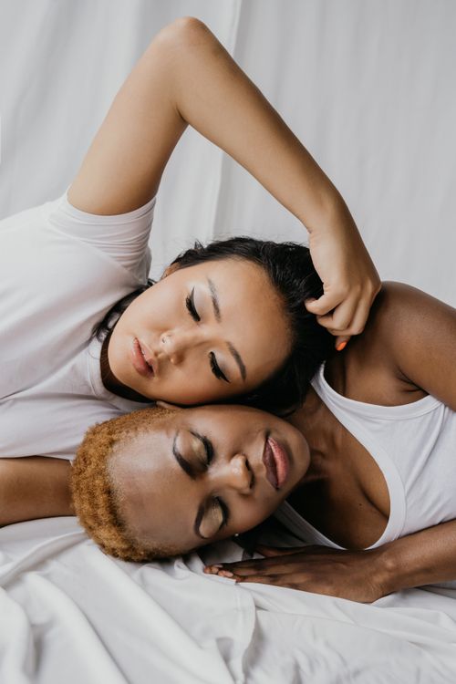 Free Two women resting peacefully, symbolizing unity and diversity. Stock Photo