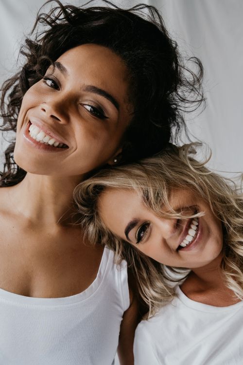 Free Two friends smiling together, showcasing joy and friendship in a close-up portrait. Stock Photo