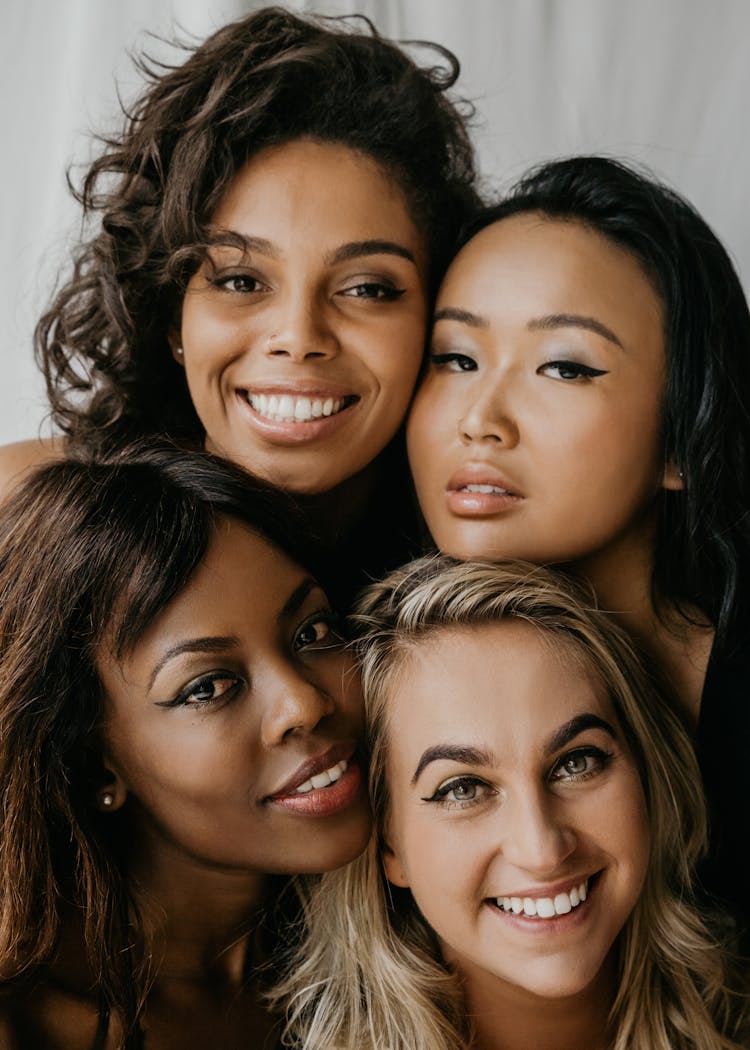 A Group Of Women Smiling With Heads Close Together