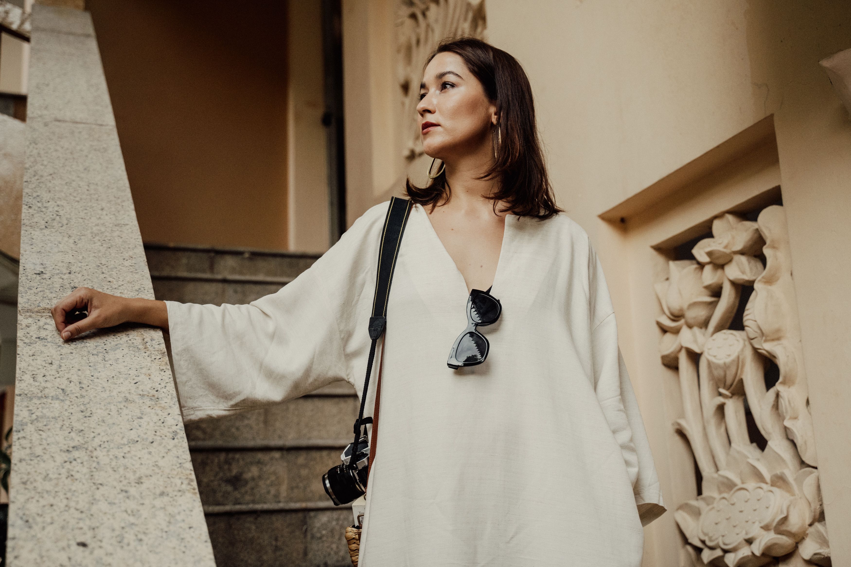 Woman in White Long Sleeve With Camera Standing on Stairs · Free Stock ...