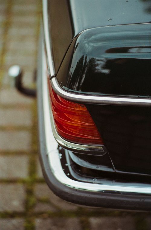 Free Detailed view of a classic black car's taillight with a vintage aesthetic. Stock Photo