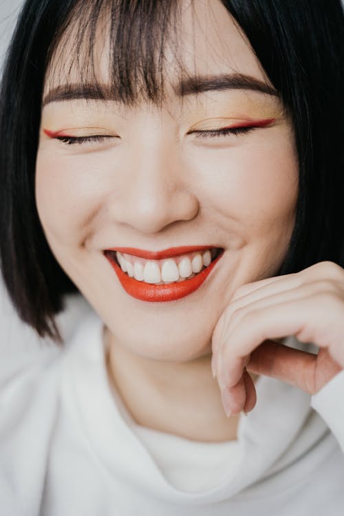 Free A Woman Smiling with Her Eyes Closed Stock Photo