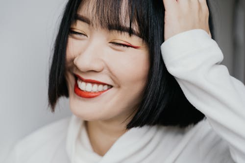 Free A Woman in White Long Sleeve Shirt Smiling Stock Photo